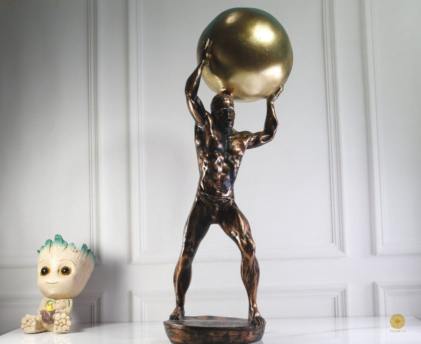 TheGharnish weight lifter figurine showing a detailed sculpture of a muscular weightlifter in a lifting pose.