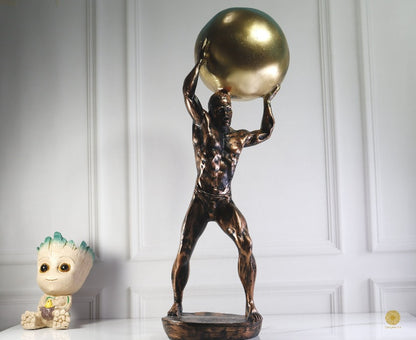 TheGharnish weight lifter figurine showing a detailed sculpture of a muscular weightlifter in a lifting pose.