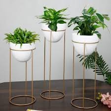Set of 3 egg-shaped metallic planters in 26, 22, and 18 inches by TheGharnish, featuring sleek, modern design for indoor or outdoor use.