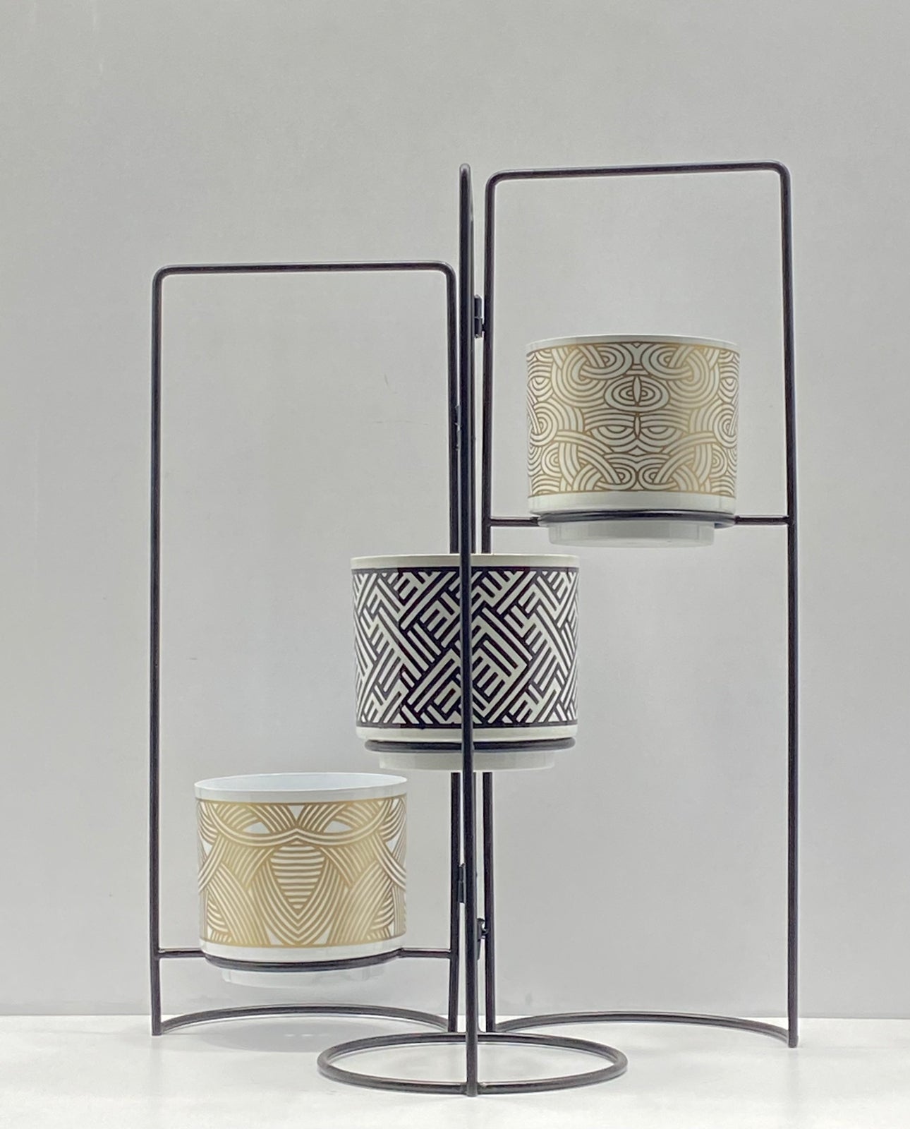 Set of 3 TheGharnish planters with stands, 20 inches tall, featuring modern design and durable material for indoor or outdoor use.
