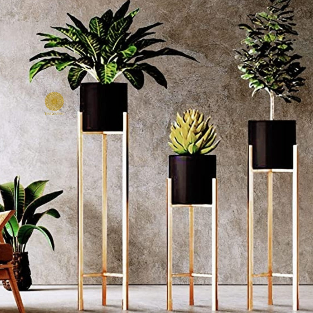 Set of three white planters with matching stands in 33, 25, and 18 inches, from TheGharnish, displayed with plants inside.