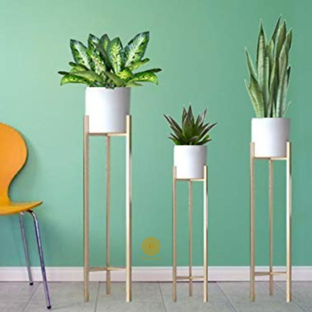 Set of three white planters with matching stands in 33, 25, and 18 inches from TheGharnish, suitable for indoor or outdoor decor.