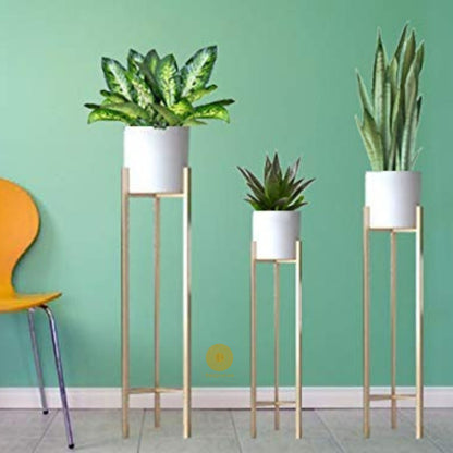 Set of three white planters with matching stands in 33, 25, and 18 inches from TheGharnish, suitable for indoor or outdoor decor.