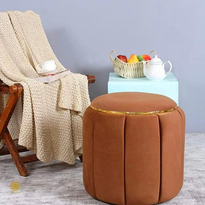 Brown pouf sitting stool by TheGharnish, designed as a dressing table sitting stool with soft upholstery and compact shape.