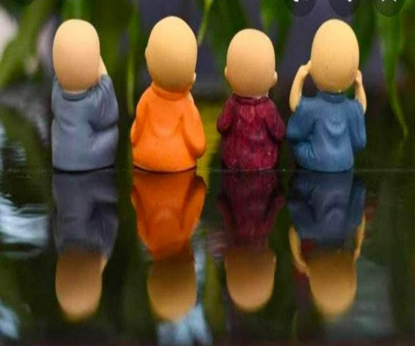 Set of four Baby Monk table top decor showpieces by TheGharnish, featuring small monk figurines for home decoration.